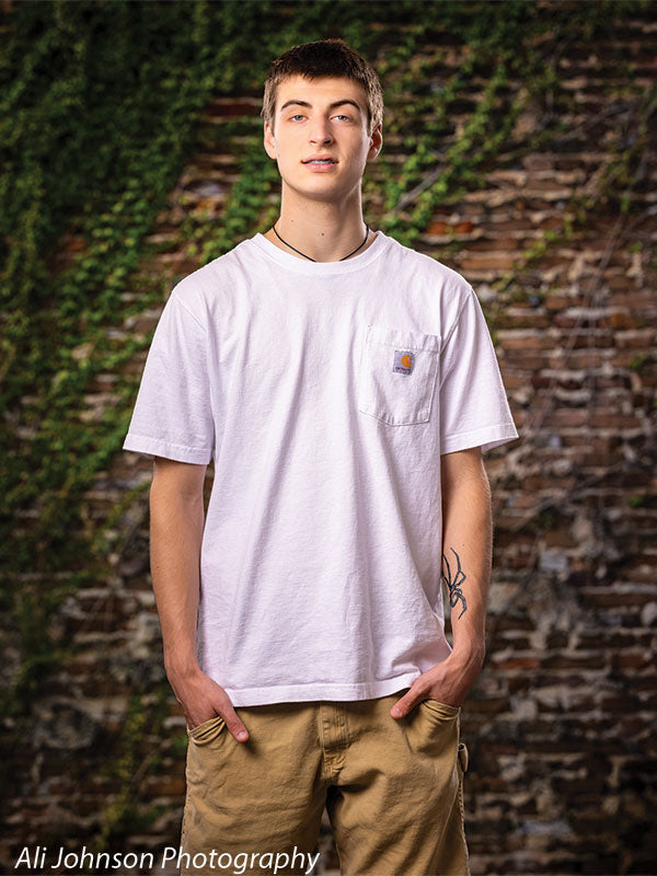 A textured brick wall photography backdrop with climbing ivy, ideal for nature-inspired and rustic portrait photography.