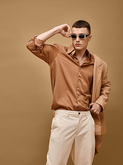 A dynamic editorial photoshoot featuring a model against a khaki brown seamless backdrop, suitable for fashion and creative projects.