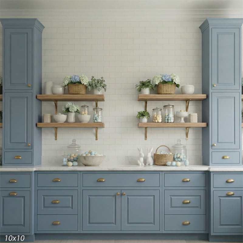 A detailed view of a studio background showing lower blue cabinets and spring decor. Ceramic rabbits and glass jars filled with eggs sit on a white counter.