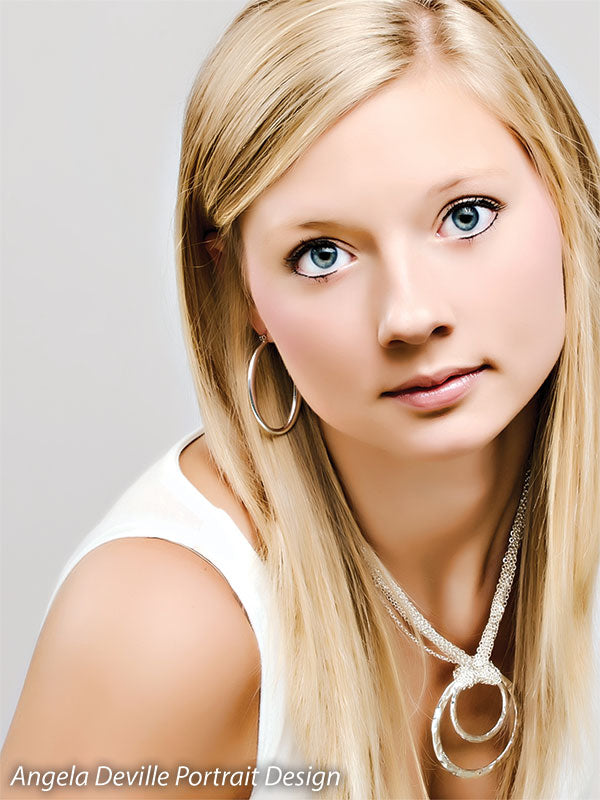 Clean gray studio background in close-up senior portrait—great for professional headshots and portfolio work.