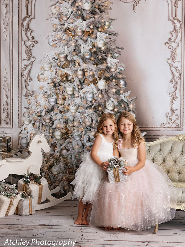 An exquisite Christmas photography backdrop with an ornately decorated white and gold holiday tree against an elegant Baroque-inspired setting.