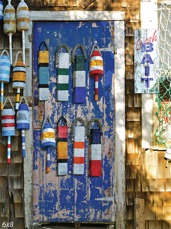 Nautical Buoys Photography Backdrop - A colorful photography backdrop featuring nautical buoys hanging on a rustic blue door, perfect for seaside-themed photoshoots.