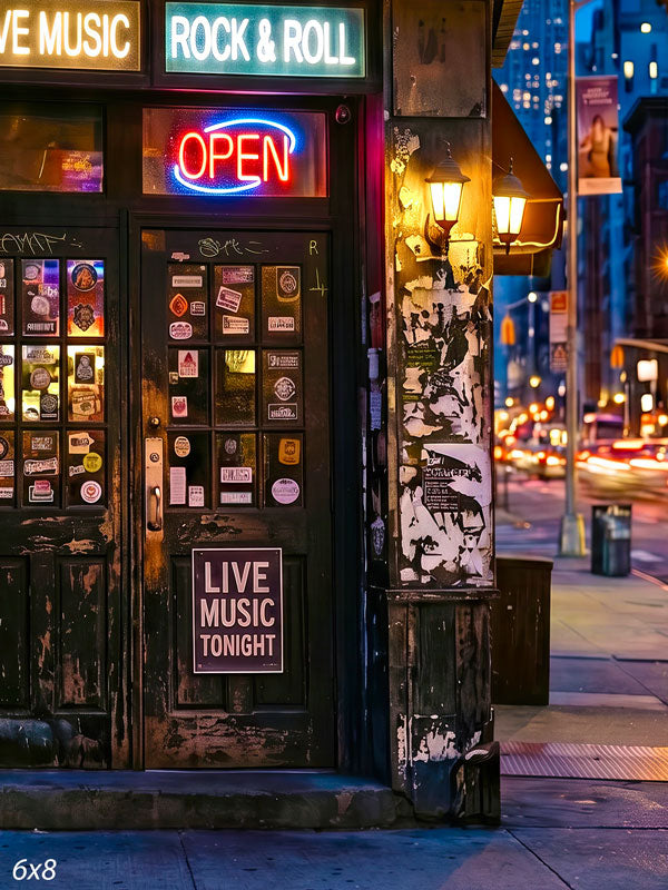Gritty city bar corner at night with glowing neon OPEN and live-music signs over a sticker-covered door and blurred street lights, an urban photography backdrop.