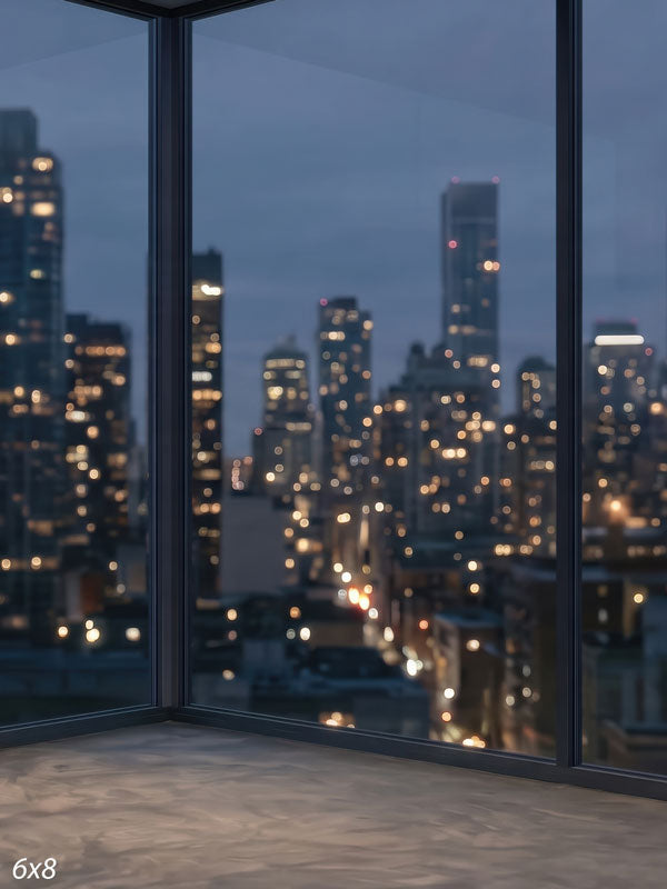 Modern room corner with floor-to-ceiling windows over a softly blurred nighttime city skyline, a city view photography backdrop.