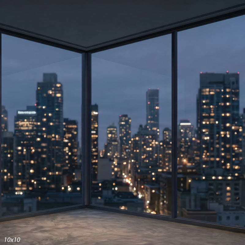 Wider view of the window corner showing both glass walls and a broader sweep of the blurred nighttime skyline, a city view photography backdrop.