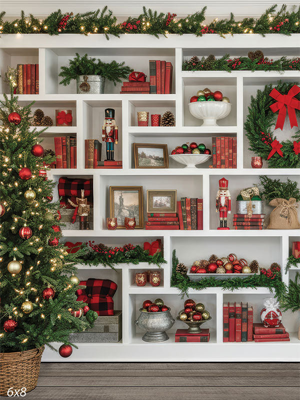 Nutcracker Nook styled holiday bookcase full wall white shelves decorated Christmas tree backdrop CP-8934