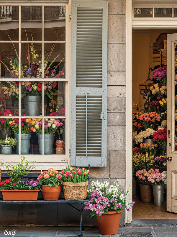 Vintage storefront floral photography backdrop with blooms and stonework, ideal for portraits.