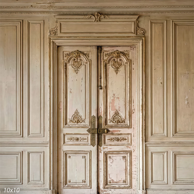 This studio background features symmetrical antique-style double doors surrounded by paneled walls, with worn paint texture and soft neutral coloring suitable for portrait photography.
