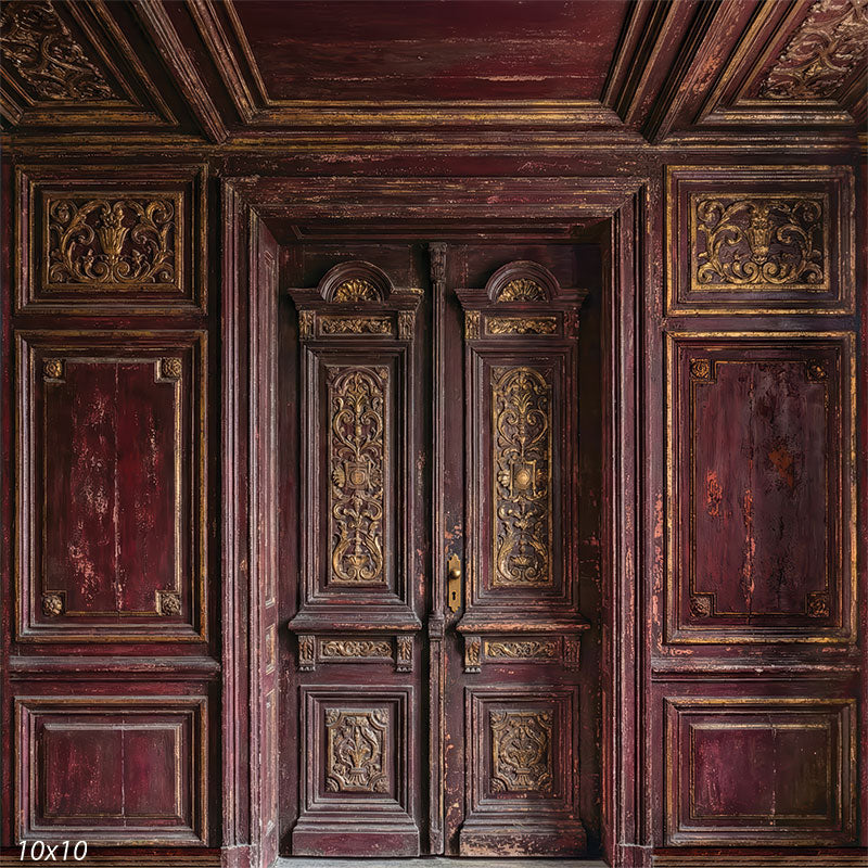 This studio background features symmetrical carved wooden double doors set in a burgundy paneled wall with visible wear, layered moldings, and classical architectural detail.