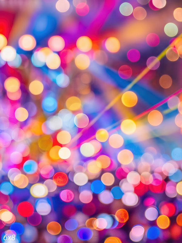 Abstract field of multicolored out-of-focus light orbs crossed by diagonal beams like festival stage lighting, a bokeh photography backdrop.