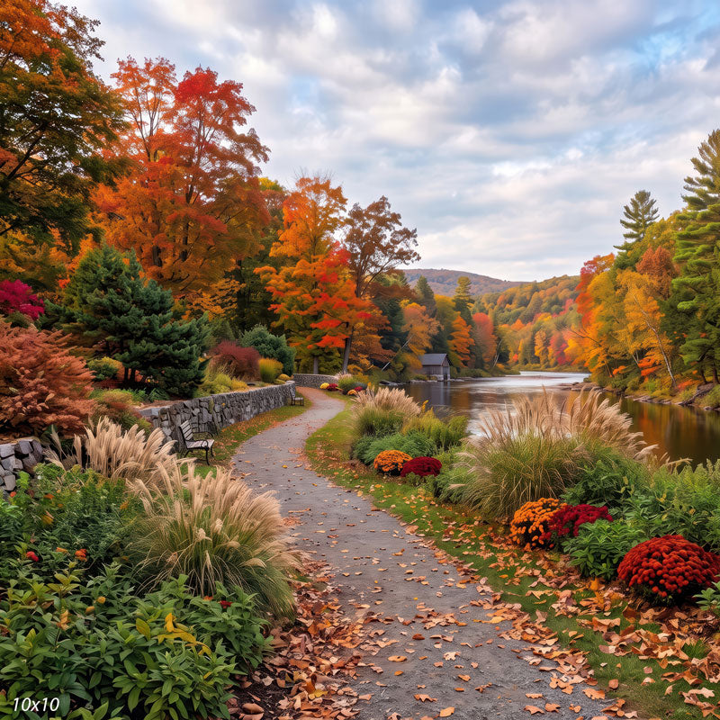 Autumn riverside photography backdrop shown wider, with more of the river, a distant boathouse, and colorful trees lining the leaf-strewn path.