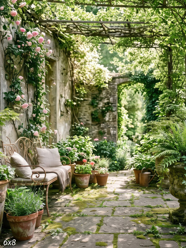 English garden courtyard with a vine-draped wood pergola, pink climbing roses and a flagstone path past an iron bench, a scenic photography backdrop.