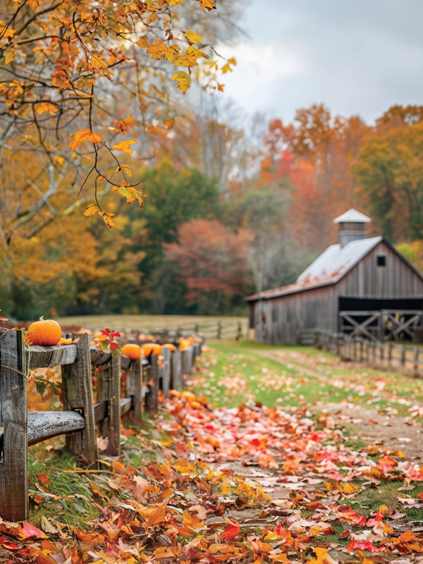 Rustic Autumn Barn Photography Backdrop - Photography backdrop featuring a rustic barn with a wooden fence lined with pumpkins, surrounded by autumn foliage.