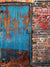 Rustic Warehouse Door Photography Backdrop - Weathered blue metal door with rust accents against a textured brick wall, featuring vintage "Delivery Parking Only" signage, ideal for photography.