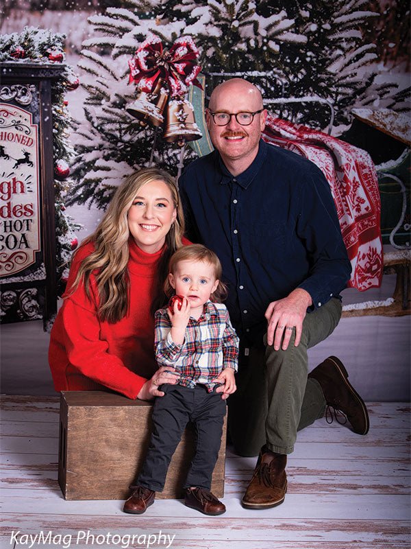 Rustic winter sleigh ride photography backdrop with a charming sleigh, snow-covered trees, and a cozy holiday atmosphere.