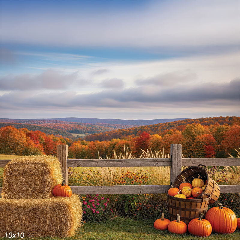 A scenic fall backdrop with hay bales, a basket of pumpkins, and vibrant autumn hills, perfect for seasonal portrait sessions.