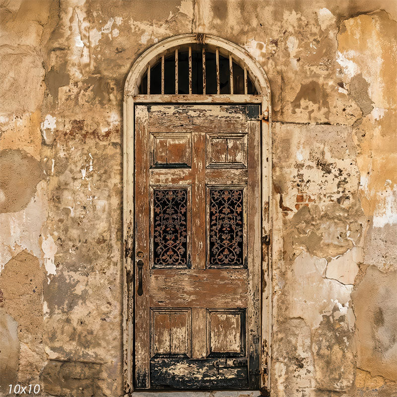 A square studio background featuring an old wooden door surrounded by cracked, worn plaster in beige and ochre hues. This photography backdrop creates an architectural setting with textured surfaces that frame a person naturally.