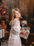 Santa’s vintage workshop photography backdrop with an old-world workbench, holiday trinkets, and nostalgic Christmas elements.