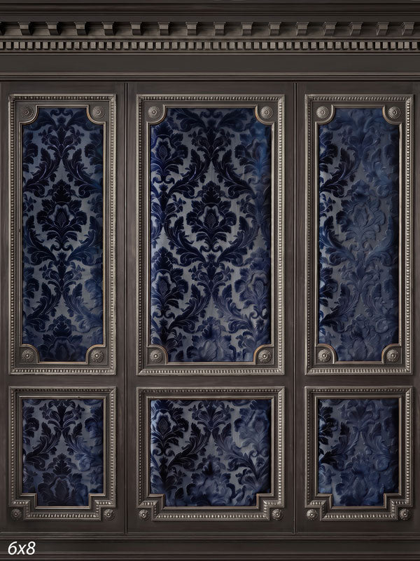 Charcoal paneled wall with silver-beaded frames and deep navy damask brocade panels, a dramatic formal photography backdrop.