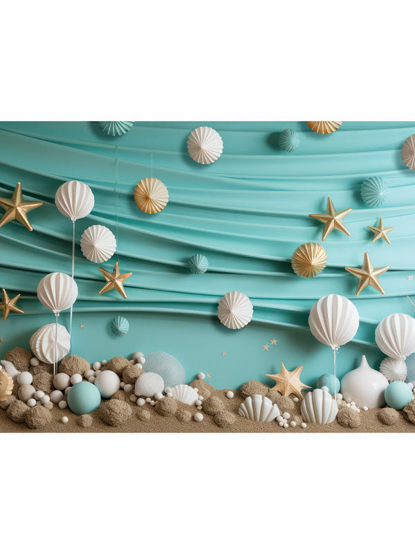 Shell Beach Birthday Party Cake Smash Backdrop - Whimsical beach-themed cake smash backdrop with aqua blue background, sandy foreground, seashells, starfish, and hanging paper lanterns.