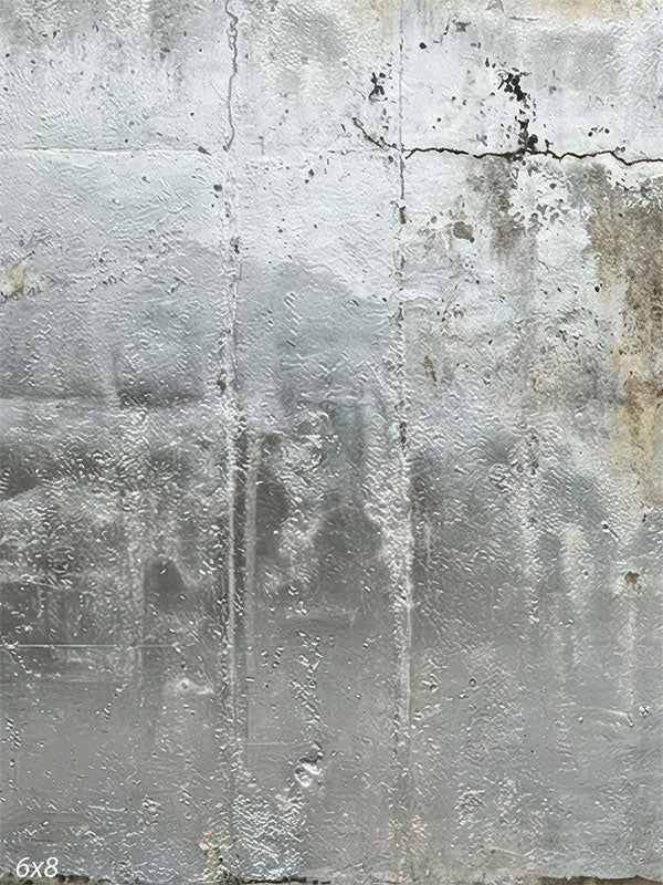 Silver gray photography backdrop showing a weathered plaster wall with soft vertical wash marks, fine cracking, and matte industrial texture.