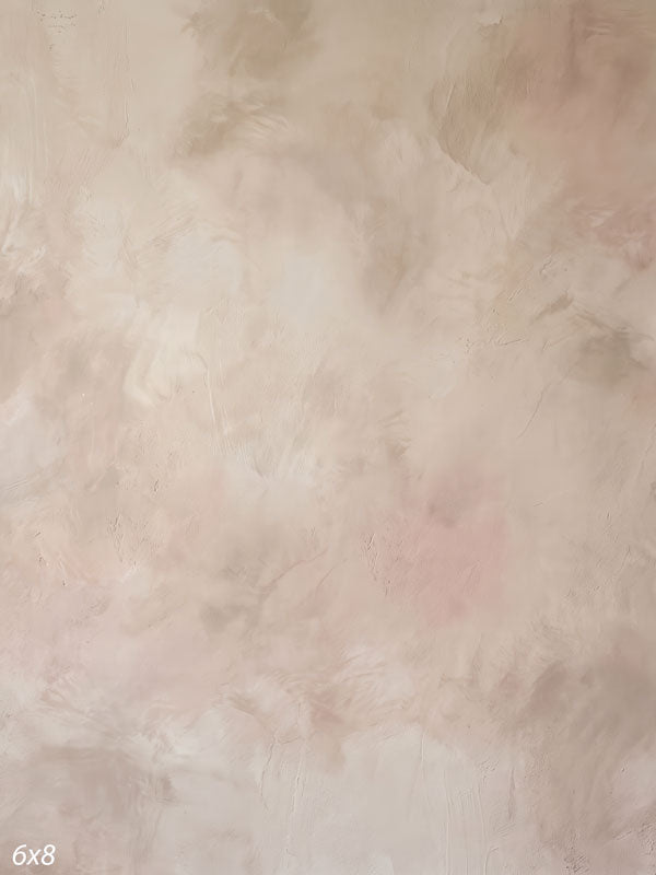 Printed photography backdrop showing soft almond beige with a faint blush, a soft mottled painterly texture with gentle tonal movement.