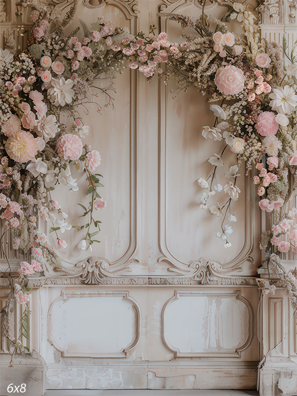 Vintage-style floral backdrop featuring ornate cream manor doors with soft pink spring flowers for photography sessions.