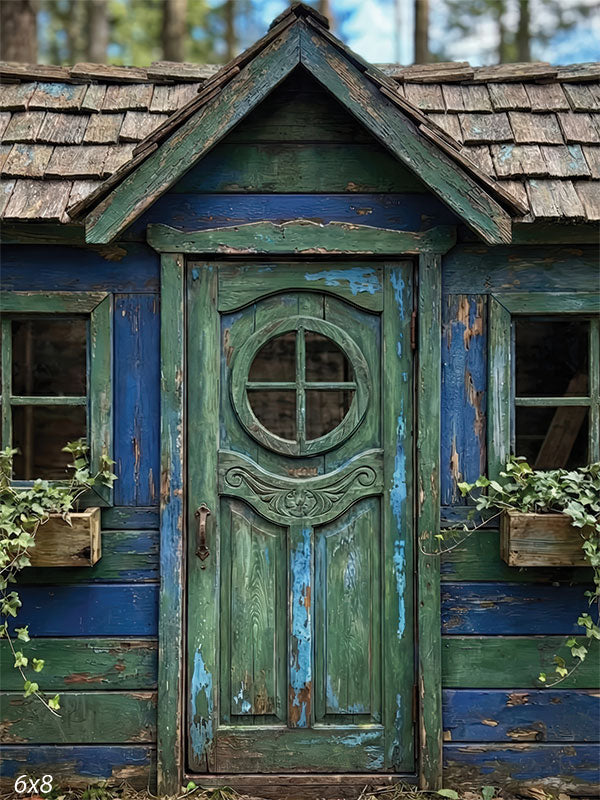 Whimsical blue and green wooden playhouse backdrop with distressed paint, central door, and rustic storybook details.