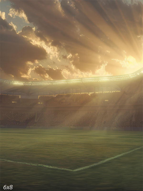 Sports stadium backdrop featuring a green field, sunset sky, and dramatic light rays shining through clouds for professional sports photography.