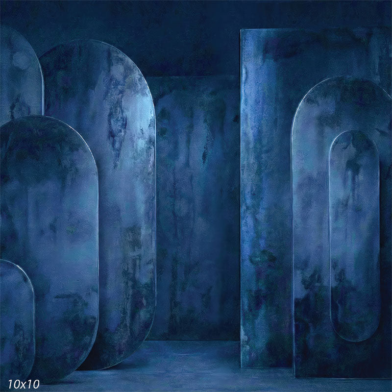 Studio background showing dark blue plaster-textured oval and rectangular panels arranged with depth for portrait photography.