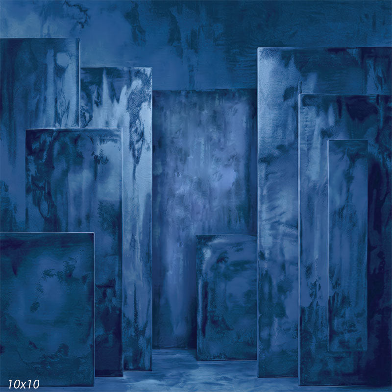 Studio background featuring dark blue plaster-textured rectangular panels arranged at varying depths for portrait photography.