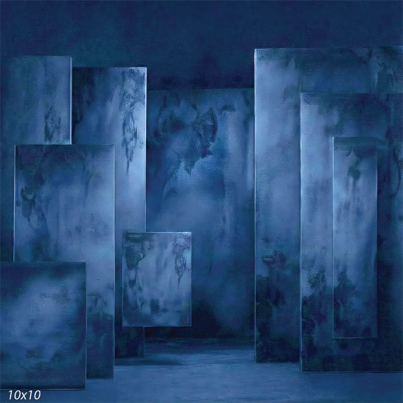 Studio background showing dark blue plaster-textured rectangular panels arranged with depth for portrait photography.