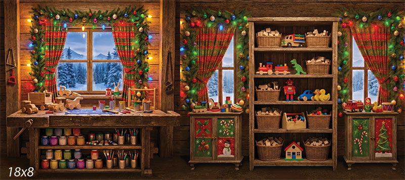 Printed photography backdrop showing a rustic Santa's workshop corner with shelves of wooden toys in wicker baskets, a craft workbench lined with colorful paint jars, string lights, garland, and snowy windows.
