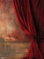 Vintage Red Curtain Photography Backdrop - Luxurious red curtain draped beside a weathered wall, creating a dramatic and sophisticated backdrop.