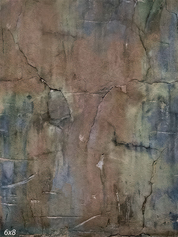 A photography backdrop showing a weathered plaster wall with muted brown tones, subtle blue and green accents, fine cracks, and layered surface texture.