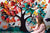 Child joyfully engaging with a butterfly in front of a multicolor tree scene with cheerful paper leaves.