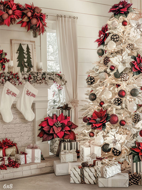 Holiday photography backdrop featuring a bright white fireplace with festive stockings, wrapped gifts, and a large white Christmas tree adorned with red and gold ornaments.