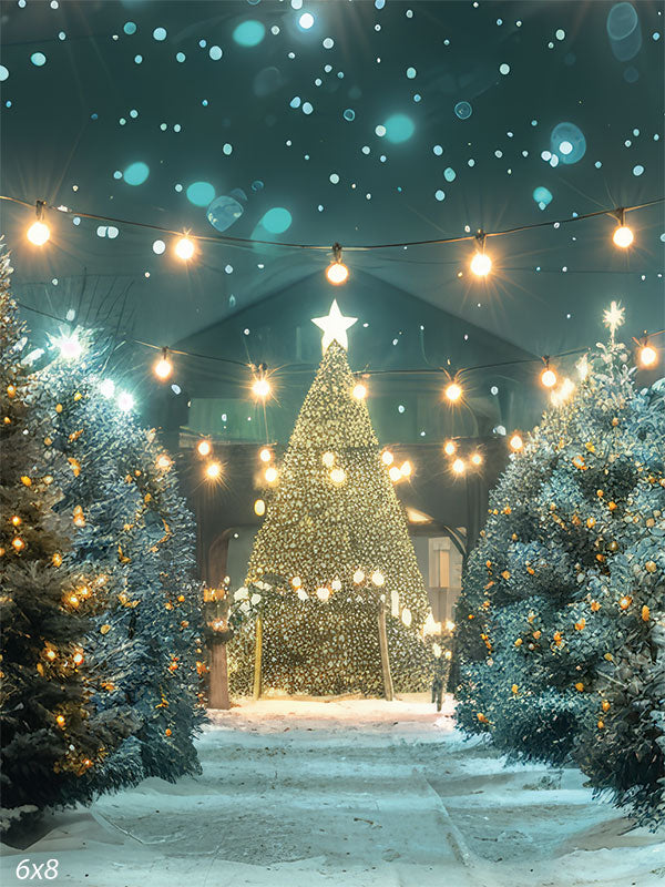 Winter Wonderland Christmas Tree Backdrop - A magical winter wonderland scene featuring a grand Christmas tree with twinkling lights and a glowing star, surrounded by snow-dusted evergreen trees with warm yellow lights, and strings of bright fairy lights overhead against a night sky with softly falling snowflakes.