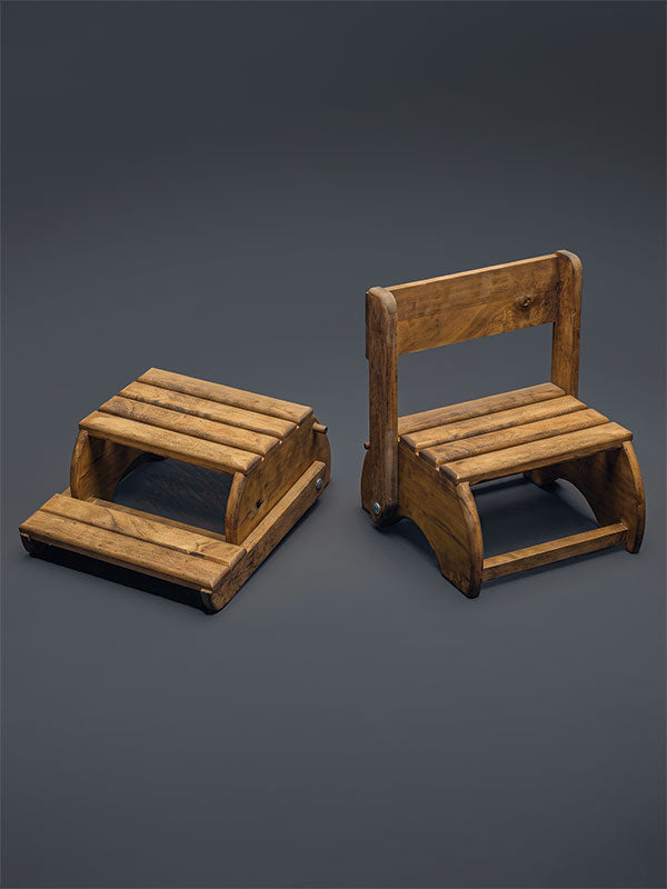 Wooden step stool bench photography prop with a slatted seat and curved sides, shown in both folded-flat and upright bench configurations on a plain grey studio background.