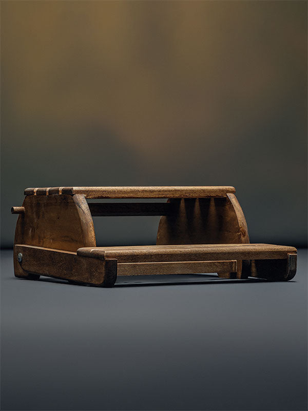 Wooden step stool bench photography prop with a slatted seat and curved sides, shown in a side-profile view folded flat as a step stool on a plain grey studio background.