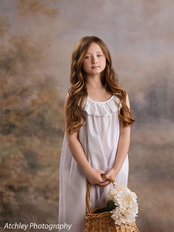 Ansel soft misty meadow with trees photography backdrop shown with a girl in a white nightgown holding a basket of white flowers, full-length CP-8845
