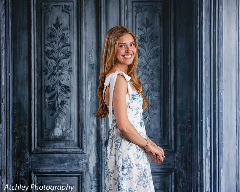 Antique Gray Double Door photography backdrop shown with a young woman in a white-and-blue floral dress in side profile, wide view CP-8792