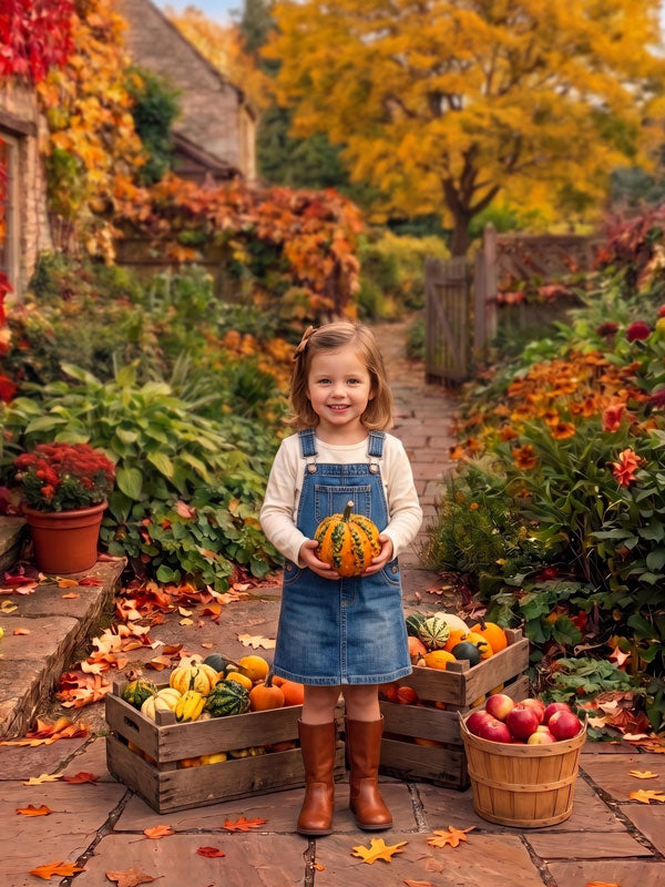 Autumn cottage garden stone path photography backdrop shown in a fall studio portrait with a young girl in a denim jumper holding a gourd beside crates of gourds and apples CP-9032
