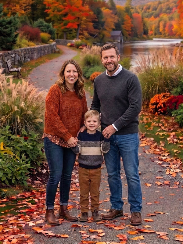 Autumn riverside path stone wall photography backdrop shown in a fall studio portrait with a family of three standing together on a leaf-covered path CP-9040