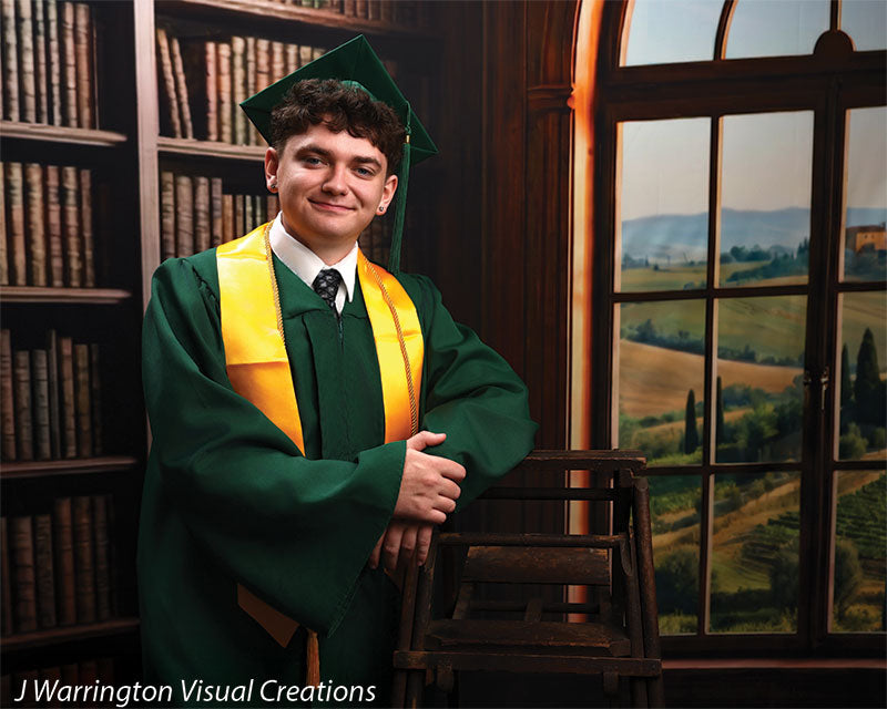 Benedict dark wood library bookcase photography backdrop shown with a senior in a green cap and gown leaning on a library ladder, wide view CP-8839