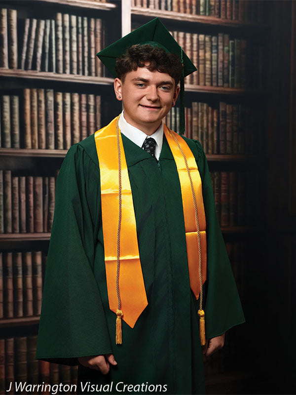 Benedict dark wood library bookcase photography backdrop shown with a senior in a green cap and gown with a gold stole, standing CP-8839