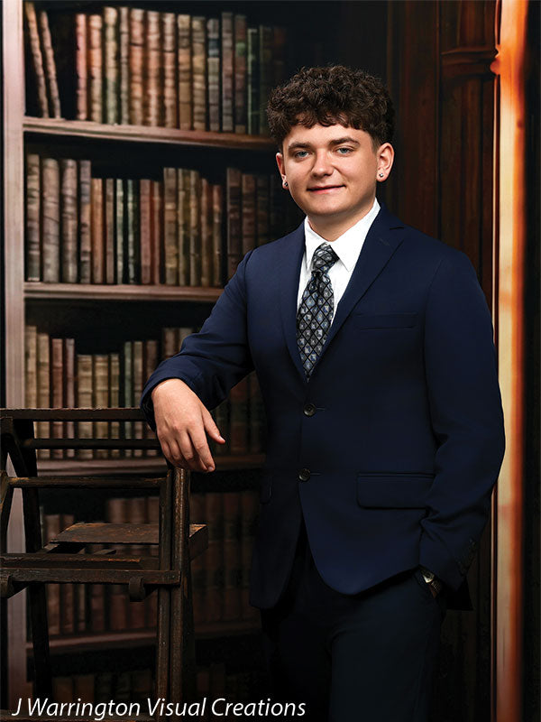 Benedict dark wood library bookcase photography backdrop shown with a senior in a navy suit leaning on a library ladder with a hand in his pocket CP-8839