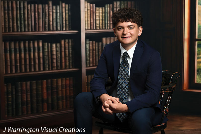 Benedict dark wood library bookcase photography backdrop shown with a senior in a navy suit seated on an antique chair, wide view CP-8839