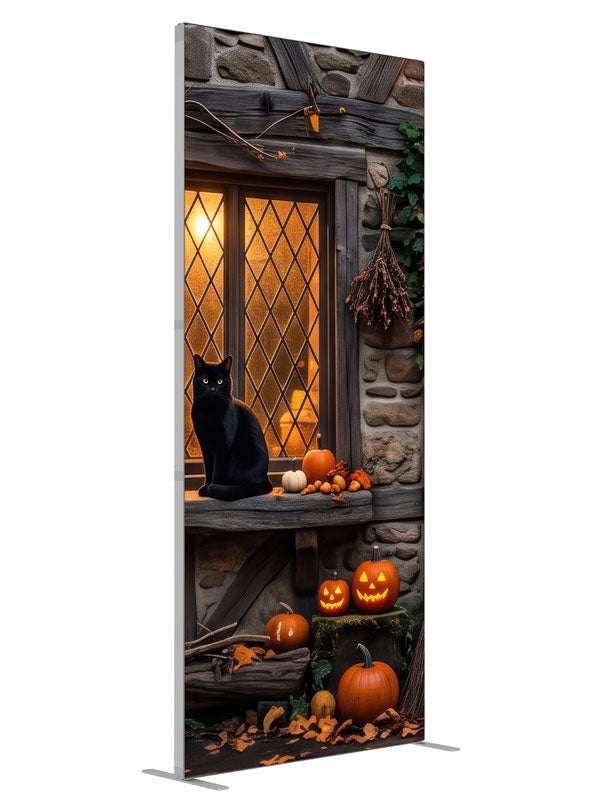 Two black cats on a glowing leaded cottage window in a stone-and-timber wall with jack-o'-lanterns, 3ft photography backdrop panel for Denny StudioEdge silicone edge frame, angled view