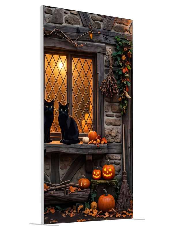 Two black cats on a glowing leaded cottage window in a stone-and-timber wall with jack-o'-lanterns, 4ft photography backdrop panel for Denny StudioEdge silicone edge frame, angled view